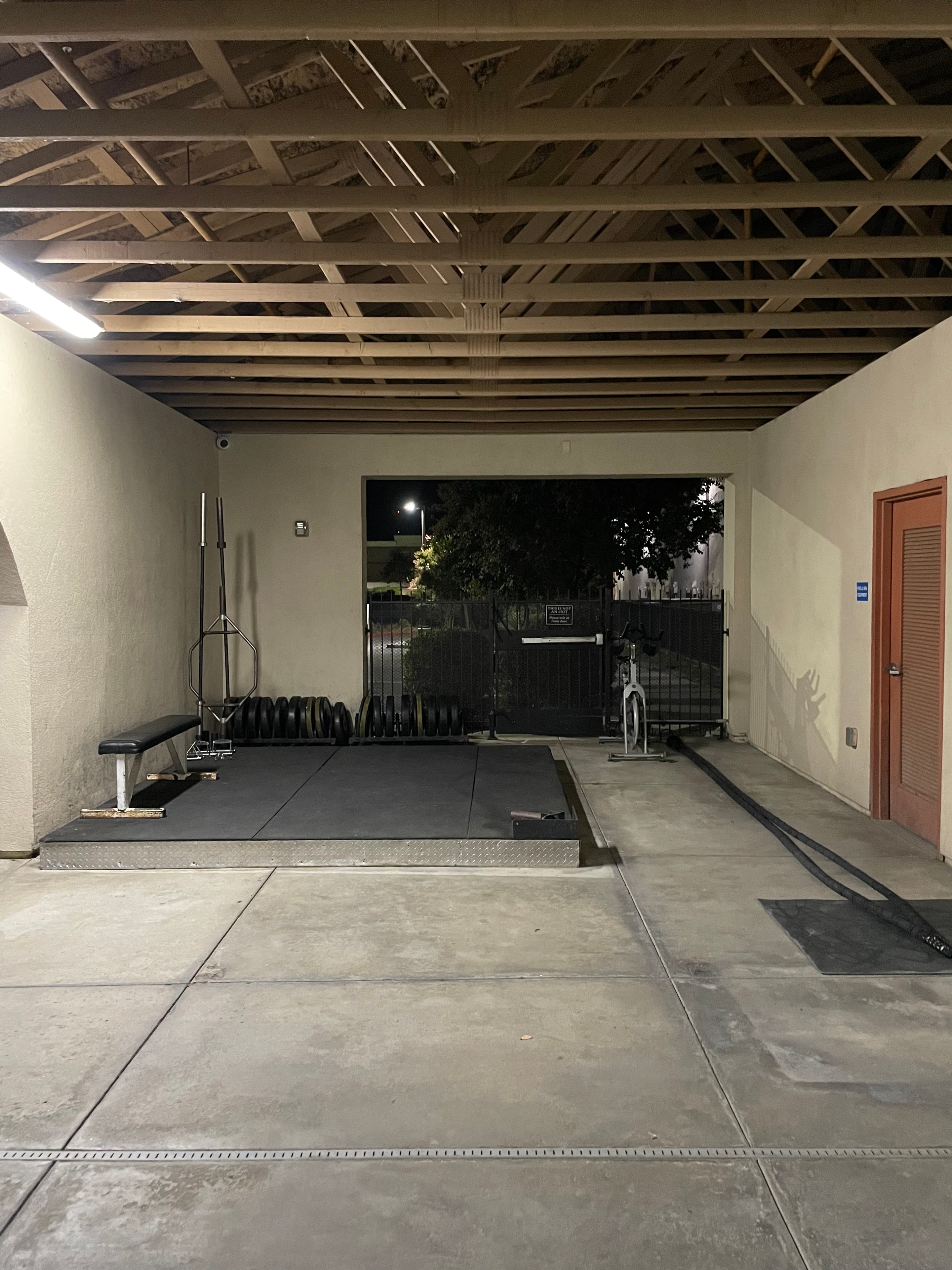 Fitness System facility corridor and powerlifting area at night