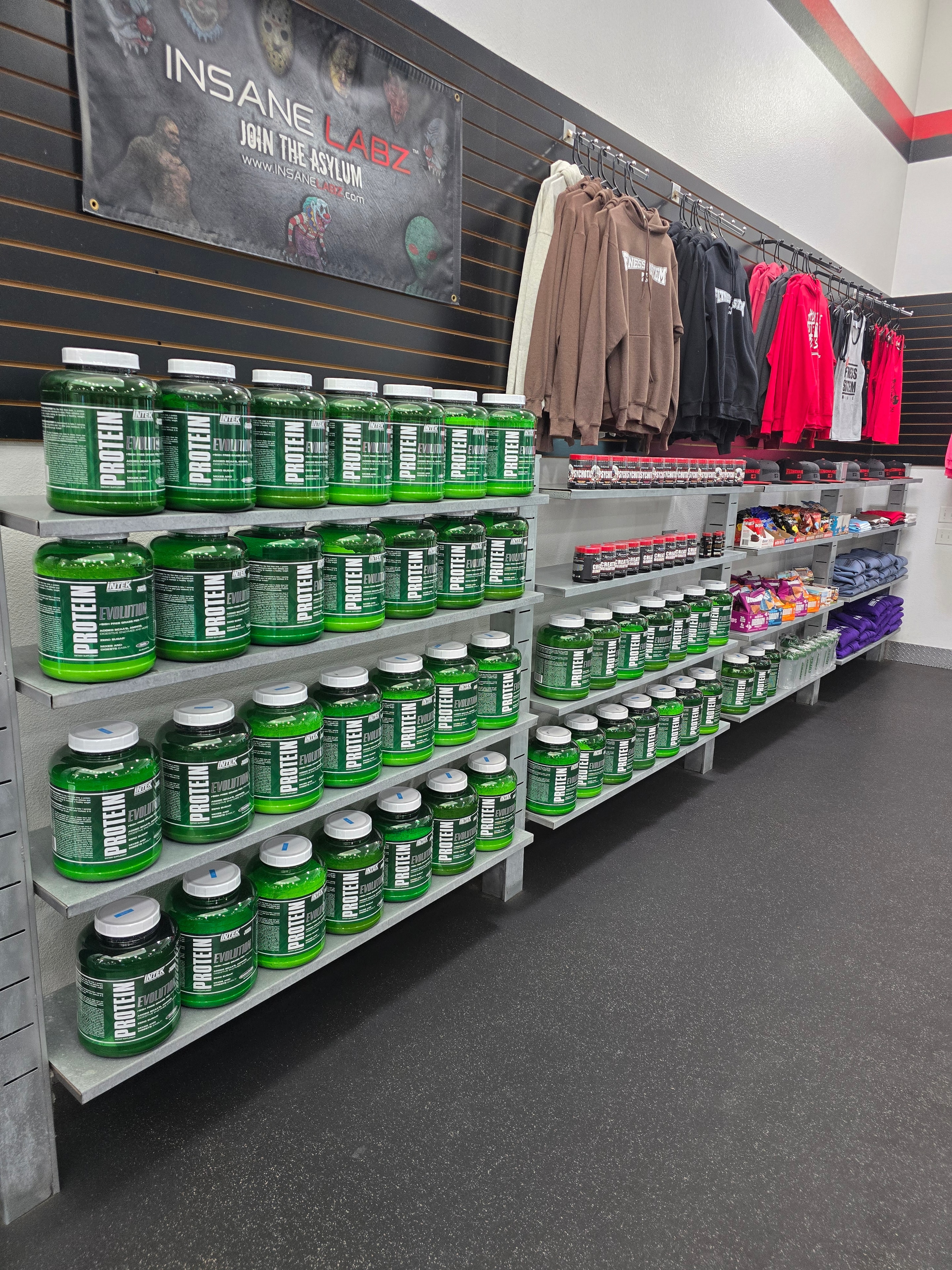 Supplement display with protein tubs and fitness apparel