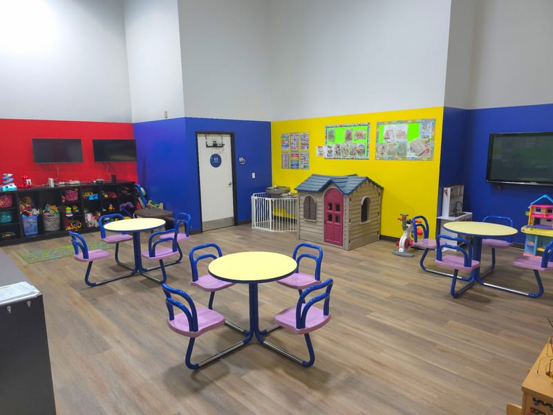 Colorful preschool classroom with play tables